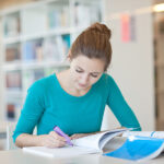 Pharmacy technician student studying with books