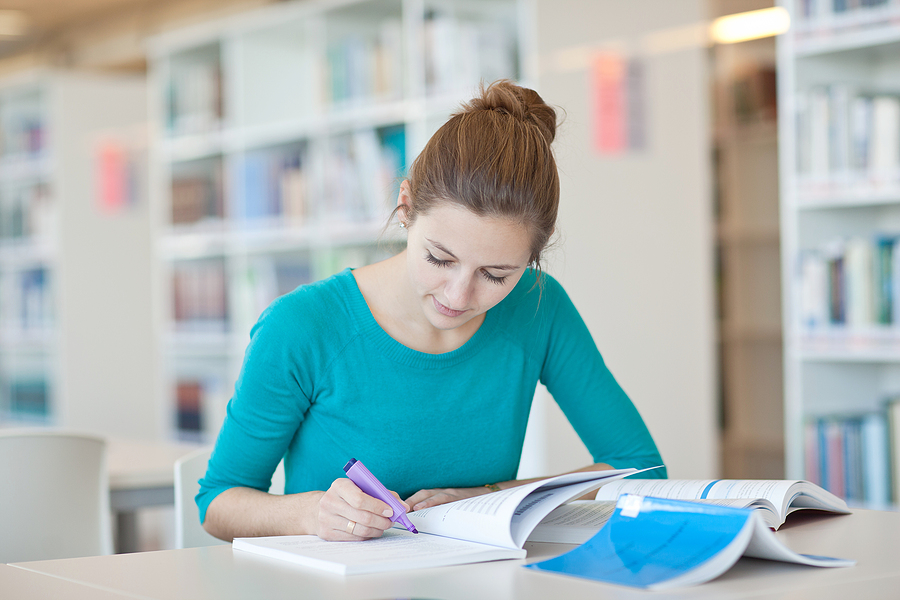 Pharmacy technician student studying with books